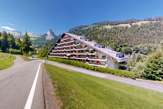 view of property featuring a wooded view and a mountain view