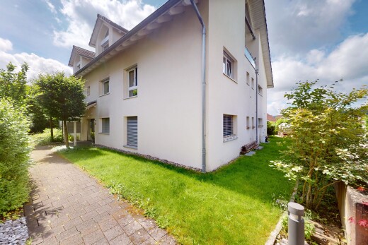 außenansicht mit stuckverkleidung, day time, property visible, rasen, und dachgaube