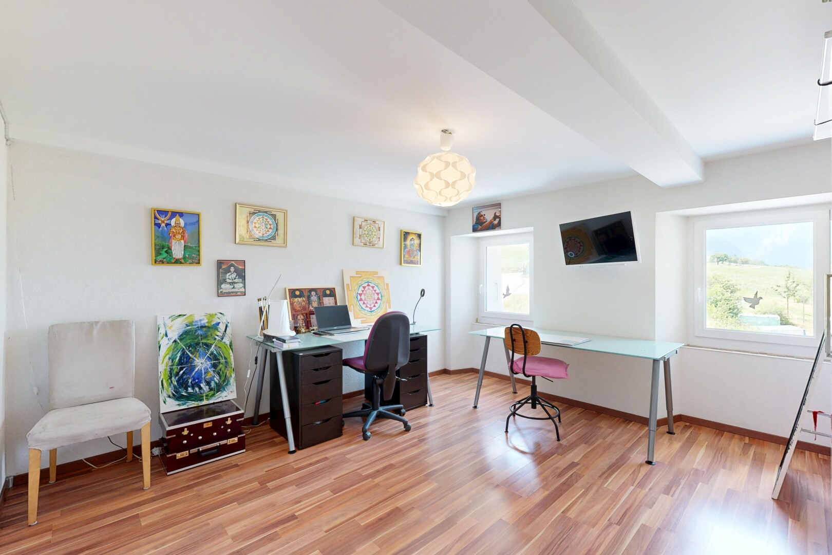 office space with beam ceiling and light wood-style flooring