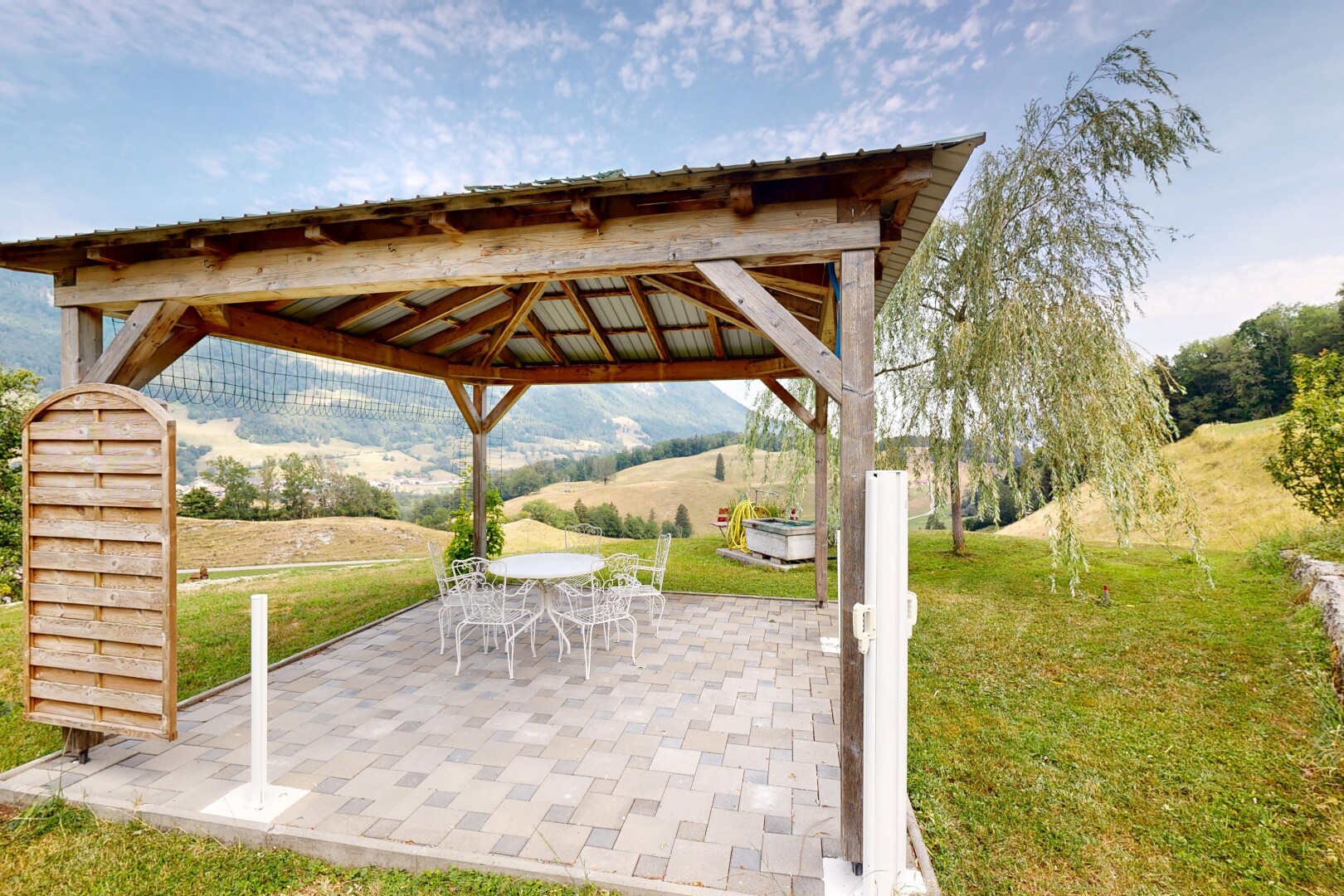 terrace featuring a patio, outdoor dining area, and a gazebo