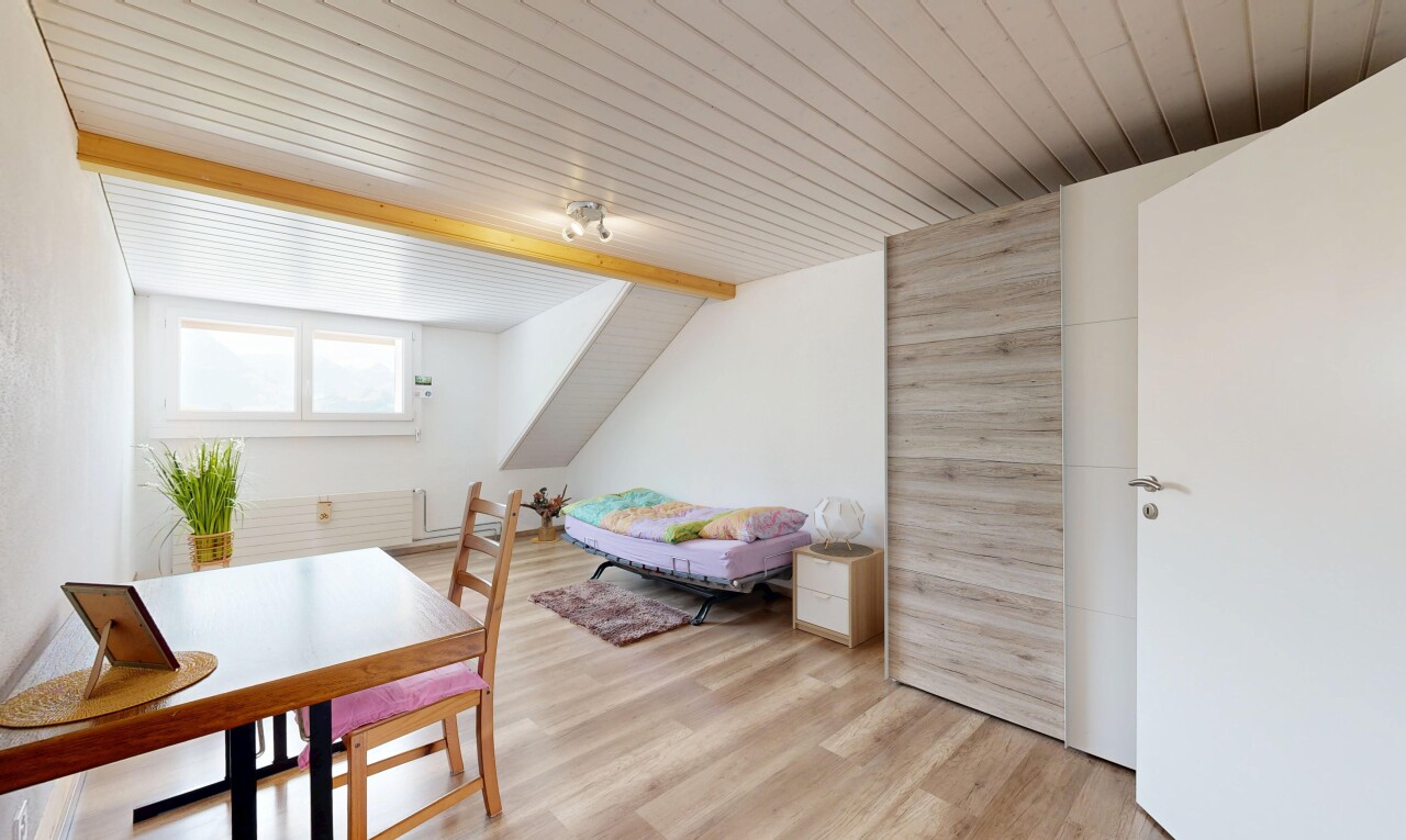 living / dining area with light wood-style floors and lofted ceiling