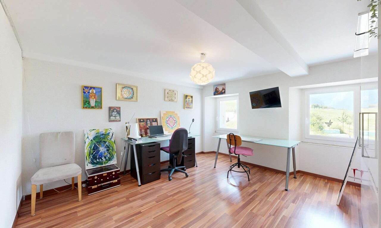office space with beam ceiling and light wood-style flooring