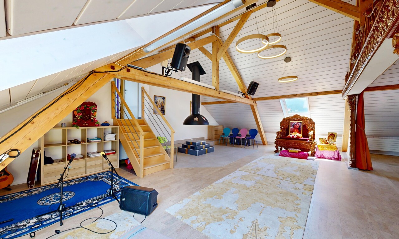 staircase featuring beam ceiling and wood finished floors