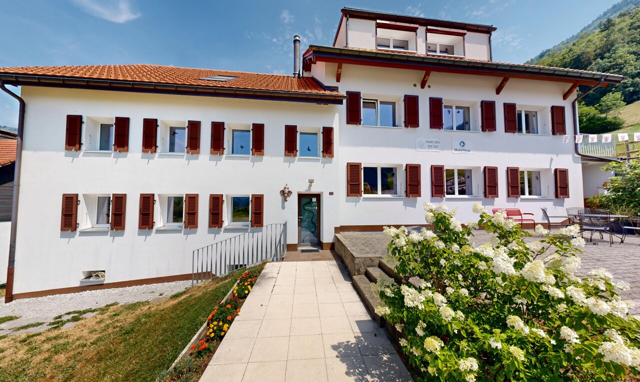 view of home with stucco siding, a tiled roof, and a balcony