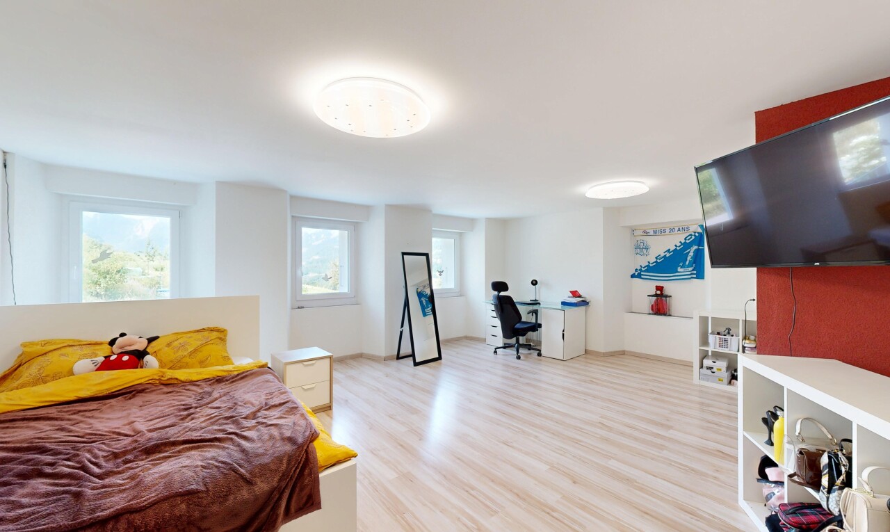 room / bedroom featuring light wood-style floors and a desk