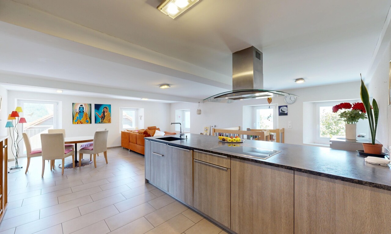 kitchen with island range hood, open floor plan, modern cabinets, wood finish cabinetry, and black electric stovetop
