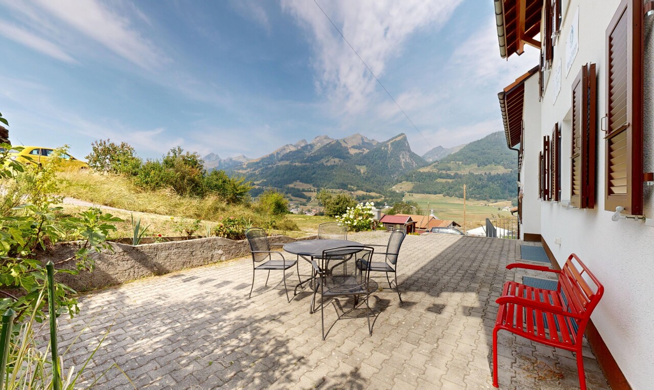 terrace with a patio, a mountain view, and outdoor dining space
