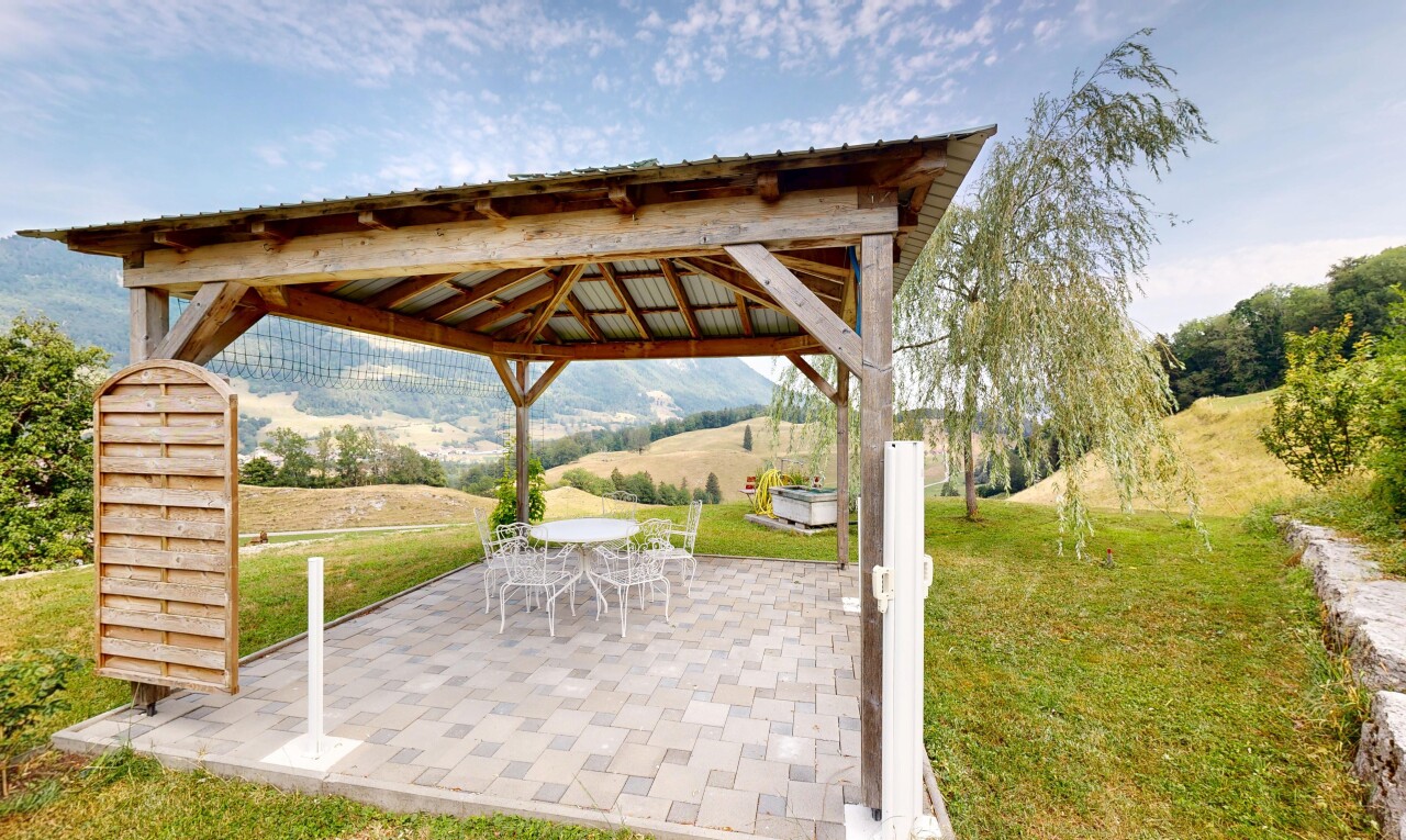 terrace featuring a patio, outdoor dining area, and a gazebo