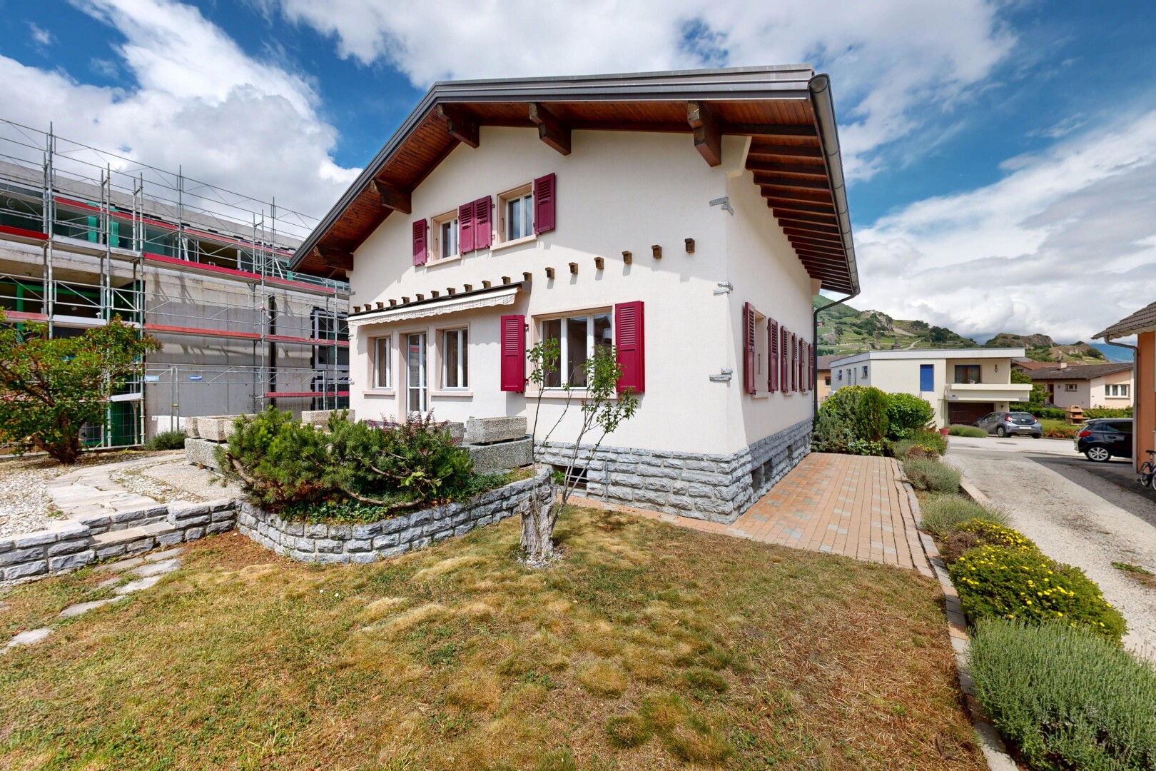 outdoor house with a lawn, stucco siding, and crawl space