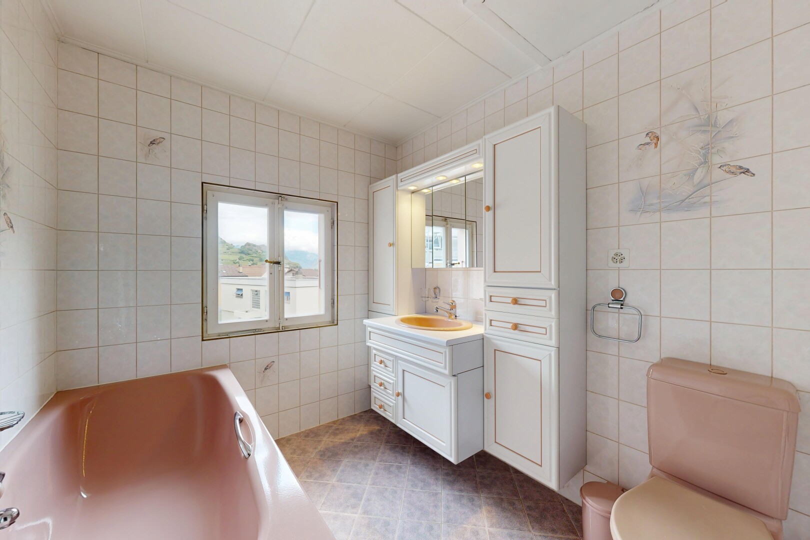 bathroom featuring tile walls, a bath, vanity, and dark tile patterned flooring