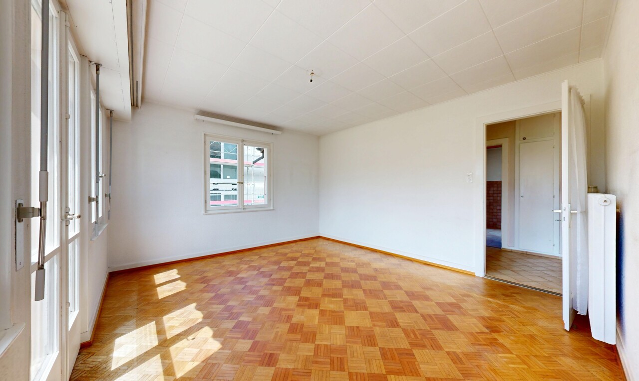 empty room featuring parquet floors and baseboards