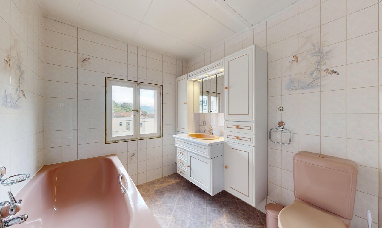 bathroom featuring tile walls, a bath, vanity, and dark tile patterned flooring