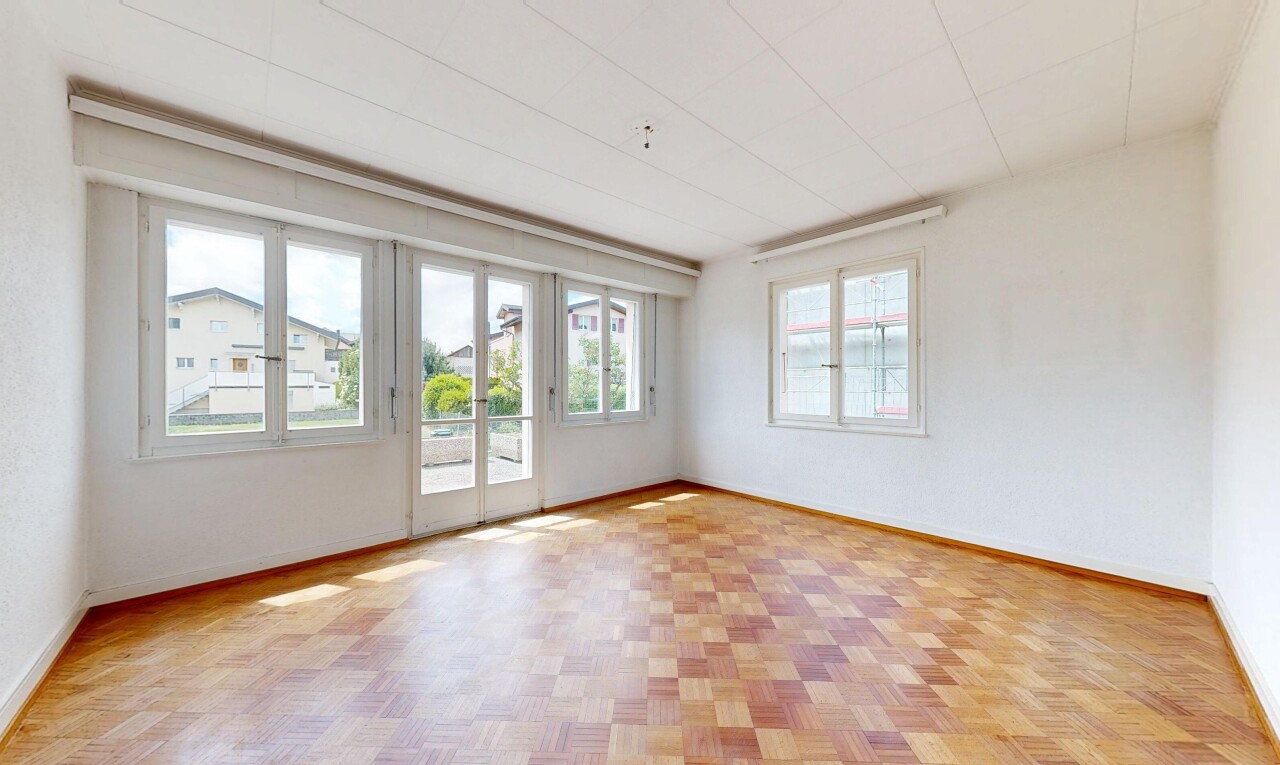 spare room with baseboards and parquet floors