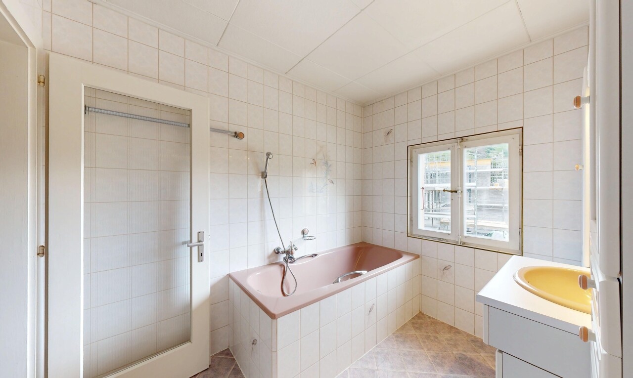 bathroom featuring tile walls, vanity, a garden tub, and light tile patterned floors