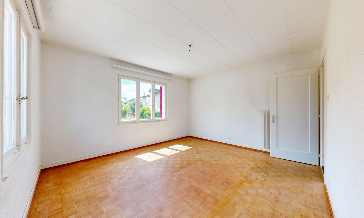 empty room with parquet flooring and baseboards