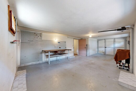 salon avec sol en béton, concrete floor, inside property, garage, et cloison sèche