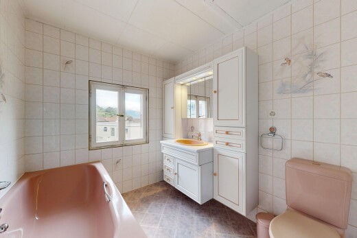 bathroom featuring tile walls, a bath, vanity, and dark tile patterned flooring