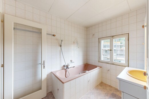 bathroom featuring tile walls, vanity, a garden tub, and light tile patterned floors