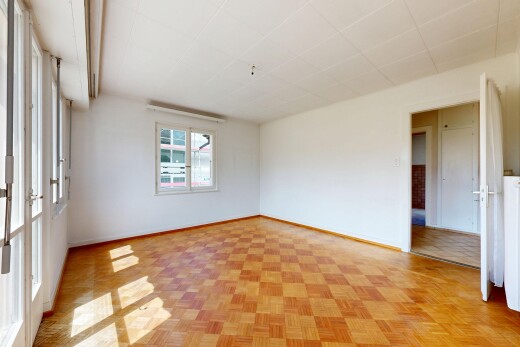 empty room featuring parquet floors and baseboards