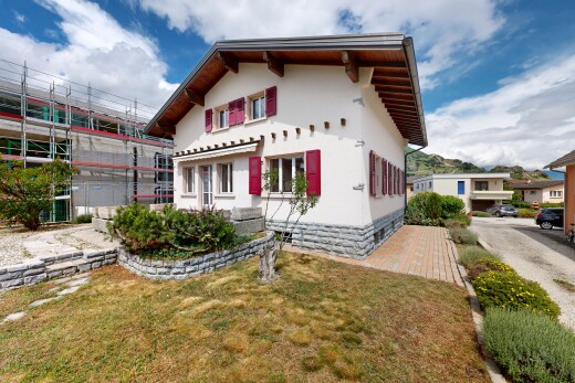 outdoor house with a lawn, stucco siding, and crawl space