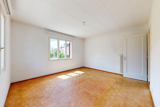 empty room with parquet flooring and baseboards