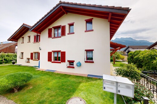 façade avec toit en tuiles, pelouse, bardage en stuc, et property visible