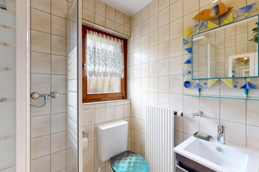 salle de bains avec salle de bain complète, douche, radiateur, toilette, et tile wall