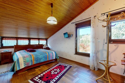 chambre avec vaulted ceiling, plafond voûté, wood finish floor, sol en finition bois, et éclairage suspendu