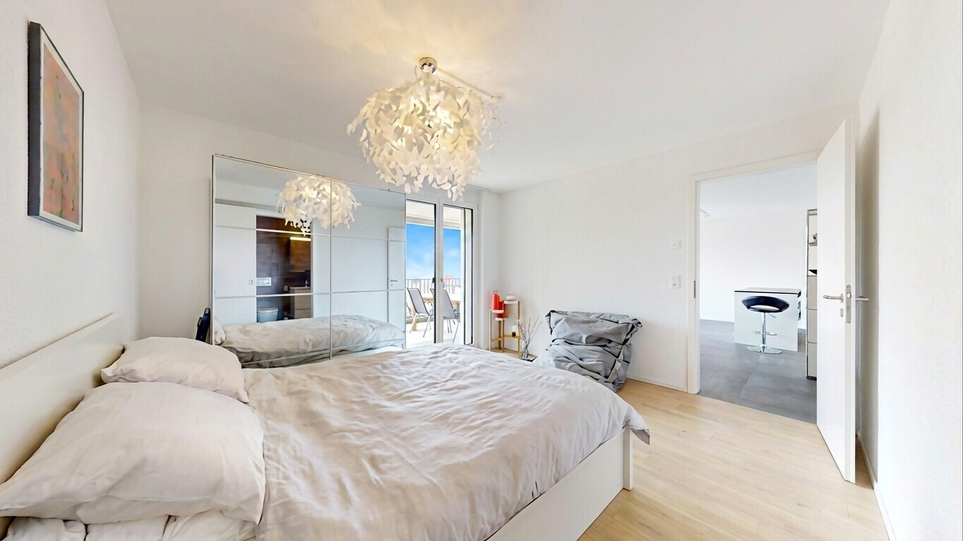 room / bedroom featuring access to outside, light wood-style flooring, and a chandelier