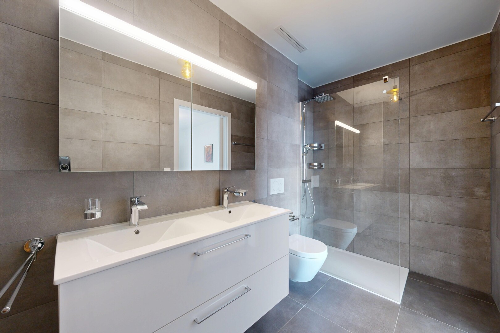 full bathroom featuring tile walls, walk in shower, double vanity, and tile patterned floors
