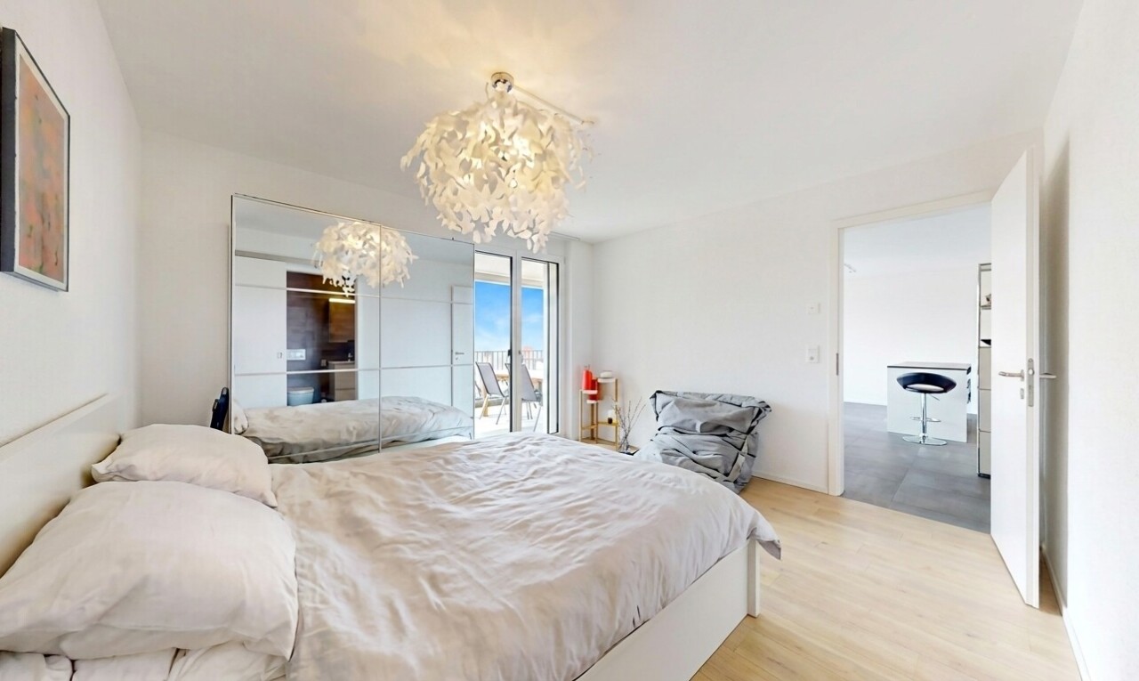 room / bedroom featuring access to outside, light wood-style flooring, and a chandelier