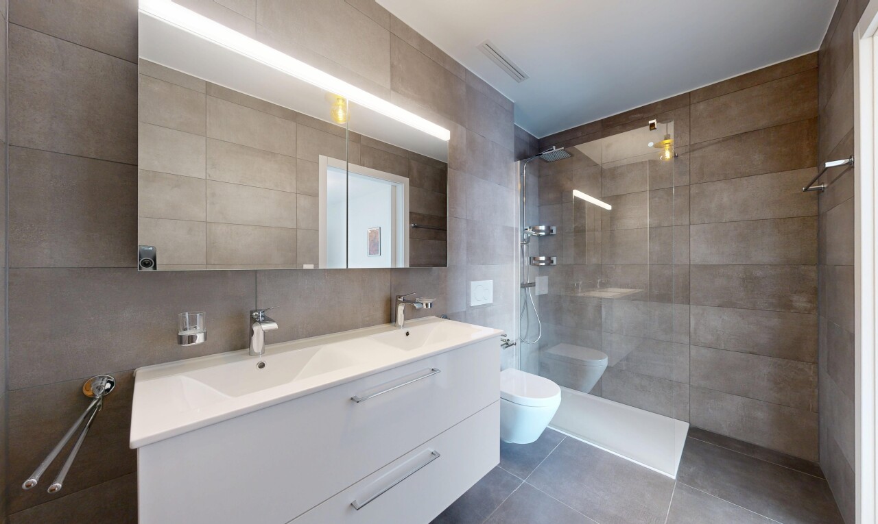 full bathroom featuring tile walls, walk in shower, double vanity, and tile patterned floors
