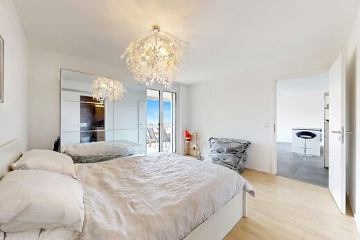 room / bedroom featuring access to outside, light wood-style flooring, and a chandelier