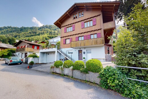 view of property featuring a balcony and stairway