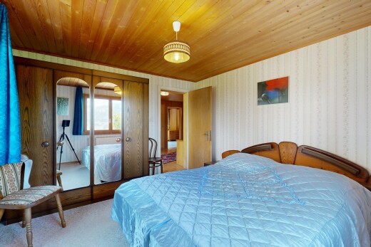 room / bedroom featuring wallpapered walls, a closet, wood ceiling, light colored carpet, and decorative light fixtures