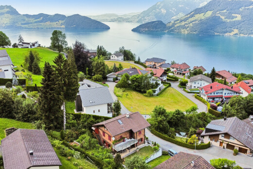 water view with a mountain backdrop and nearby suburban area