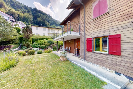 garden featuring a lawn, a balcony, and a patio area