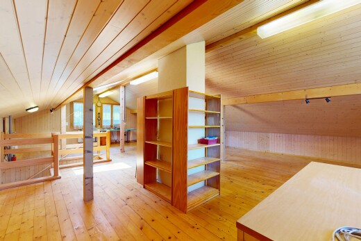 spare room with a vaulted wood ceiling, light wood-type flooring, and wooden walls