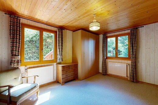 unfurnished room featuring radiator heating unit, radiator, light colored carpet, wooden walls, and wooden ceiling