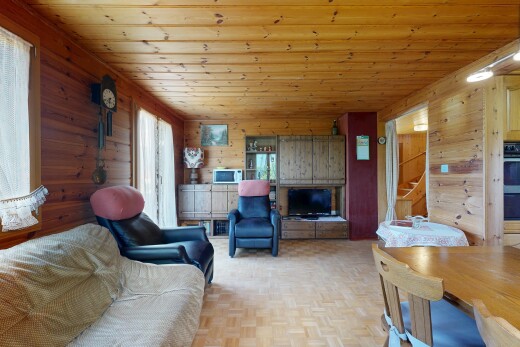 living area with wood walls, parquet floors, and wooden ceiling