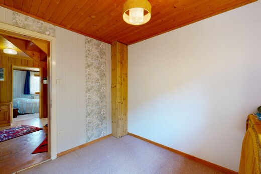 unfurnished room featuring wood ceiling, light colored carpet, and decorative light fixtures