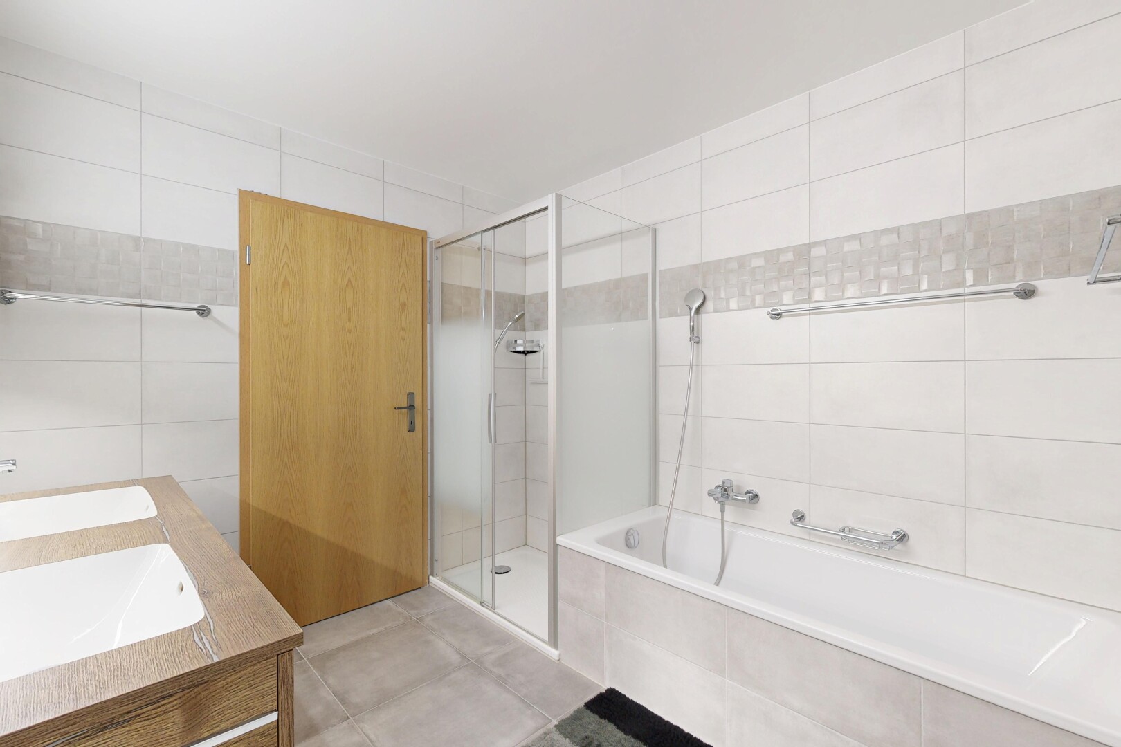 full bath with a stall shower, tile walls, a bath, double vanity, and tile patterned flooring