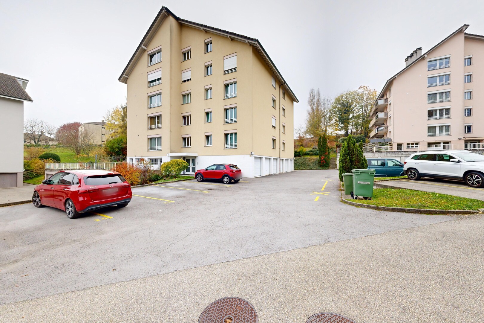 view of apartment building / complex featuring uncovered parking
