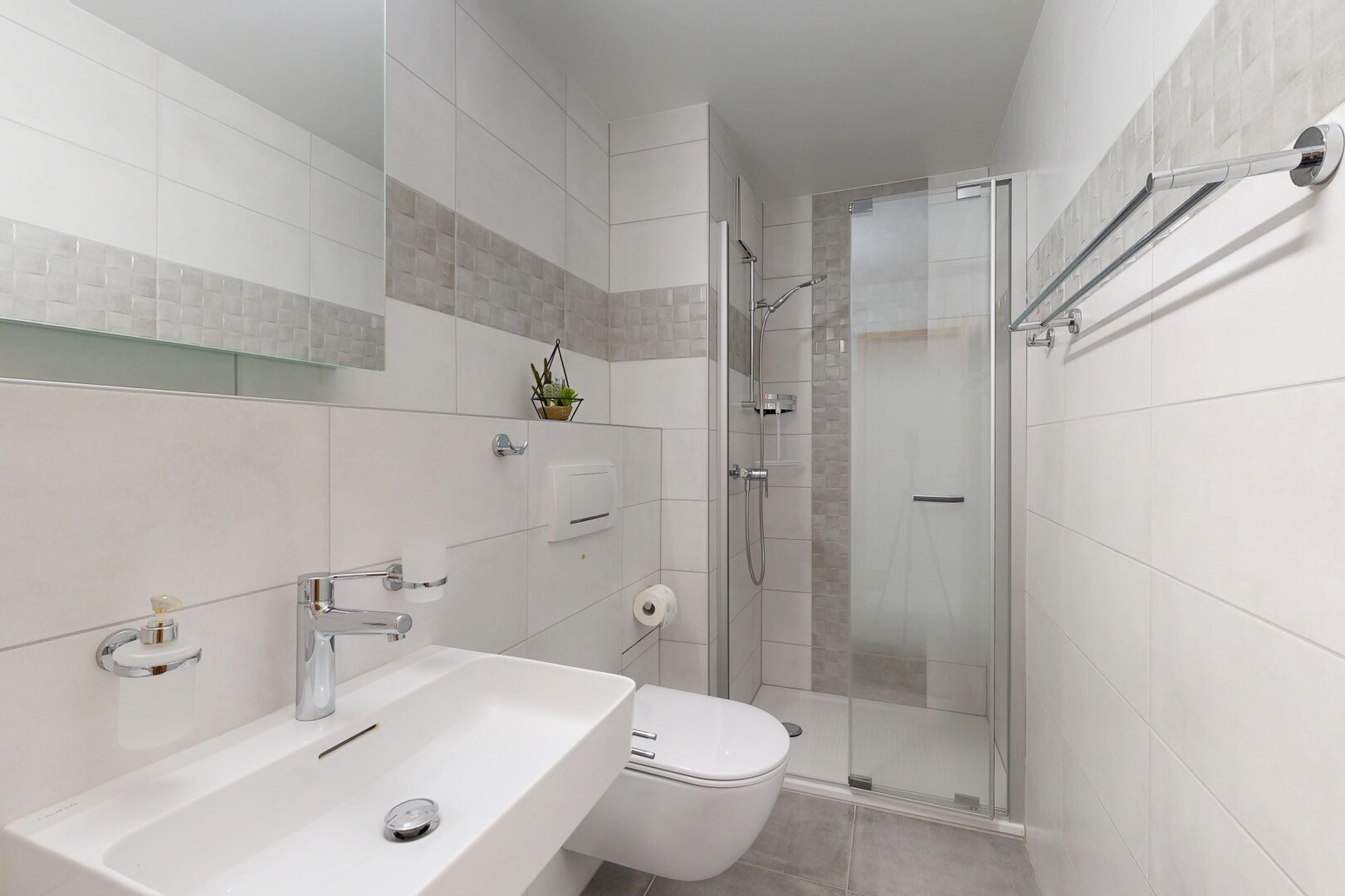 bathroom featuring tile walls and a stall shower
