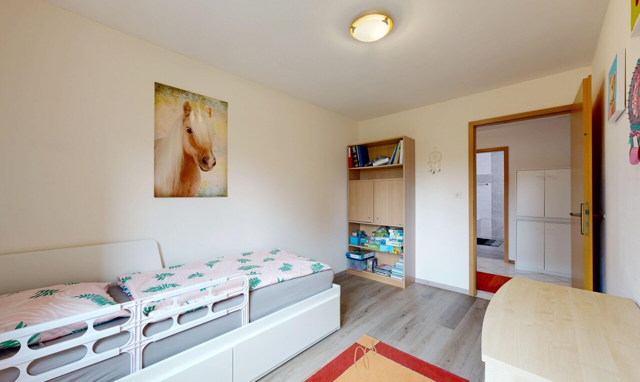 room / bedroom featuring light wood-type flooring and baseboards