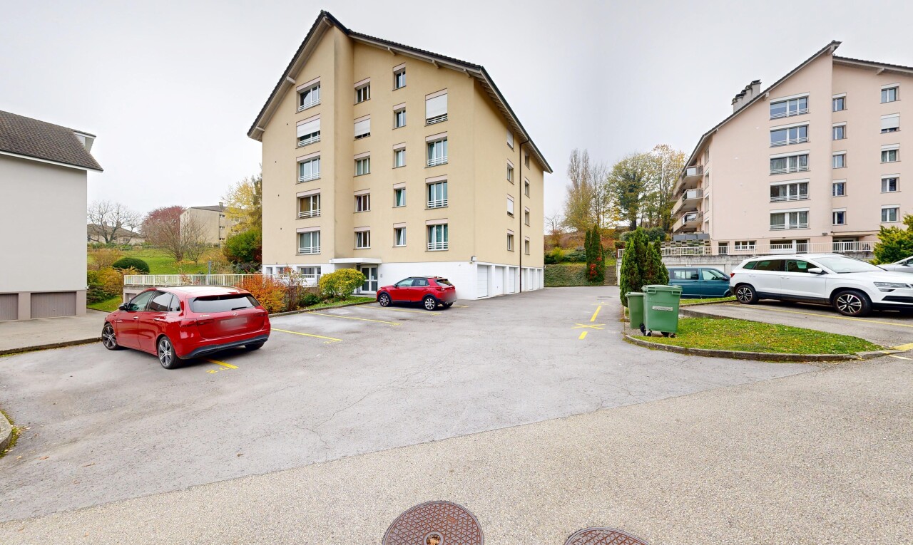 view of apartment building / complex featuring uncovered parking