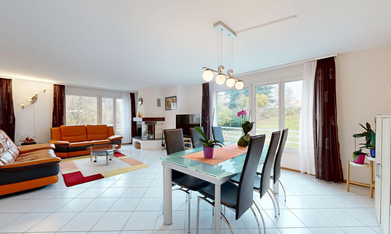 living area featuring light tile patterned flooring and a chandelier