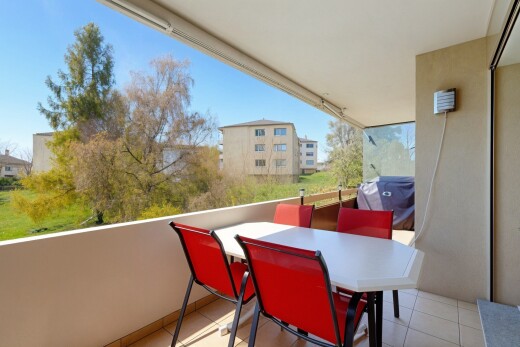 terrace with outdoor dining space, a grill, and a balcony
