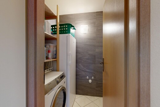 laundry room with washer / dryer, light tile patterned floors, and tile walls