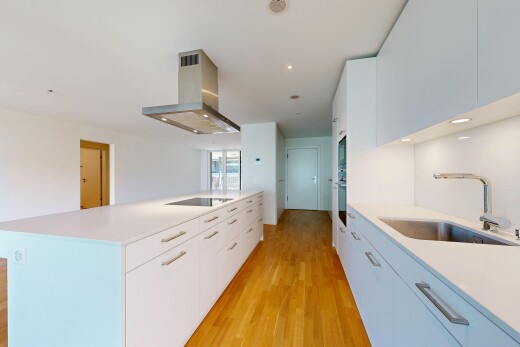 kitchen with recessed lighting, white cabinets, island exhaust hood, a center island with sink, and light wood-style flooring